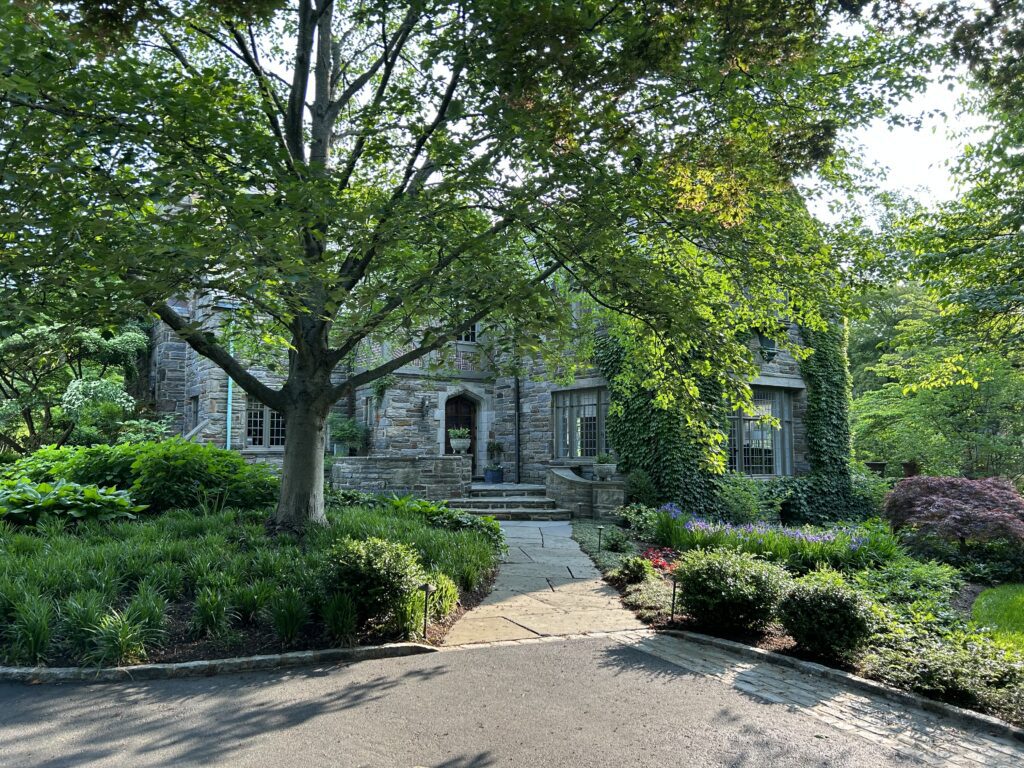 Stone Entry Framed by Low Garden Volumes